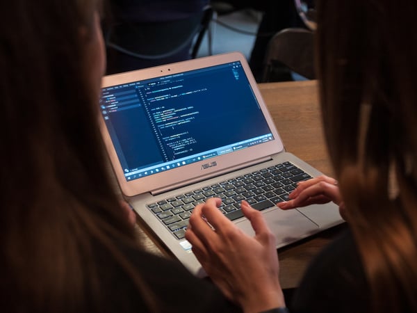 Anonymous women using laptop at desk